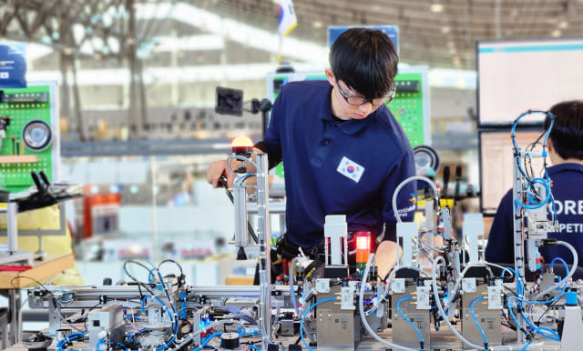 A South Korean national athlete is concentrating on his task while competing in the International Skills Olympics.